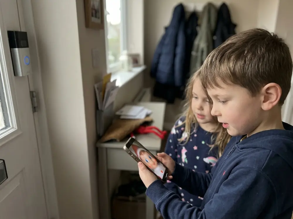 Toy elf doll 'triggers' the doorbell camera overnight; in the morning the kids review the footage — a blurry elf held up to the lens — then hunt…