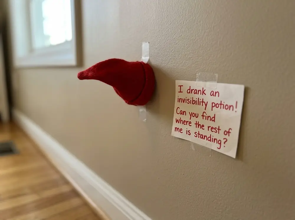 Tape only the toy elf doll's hat to the wall with a note: 'I drank an invisibility potion