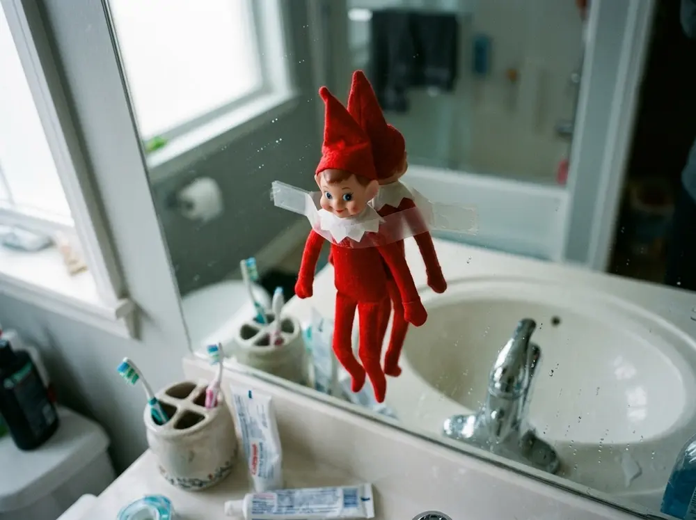 Tape the toy elf doll to the bathroom mirror so it's the first face they see brushing teeth