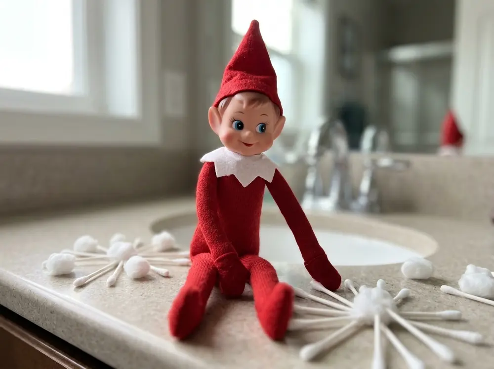Toy elf doll arranges Q-tips and cotton balls into snowflake patterns across the bathroom counter — so beloved that kids have been caught copying…