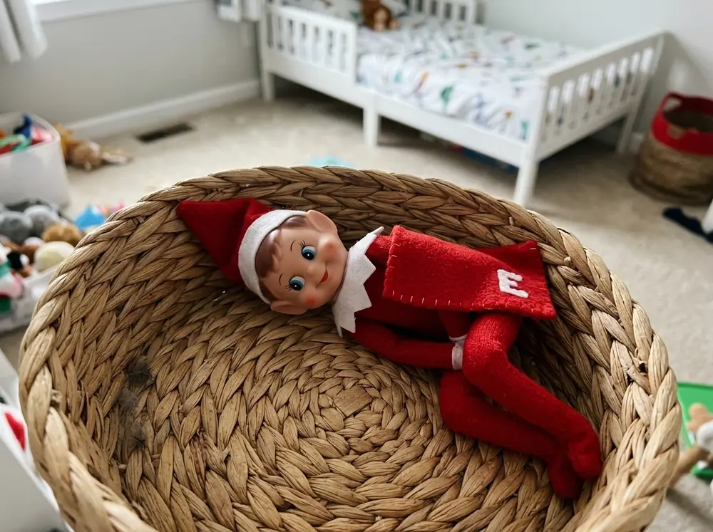 Every stuffed animal moves to a different kid's bed overnight; the toy elf doll snoozes in the now-empty toy basket