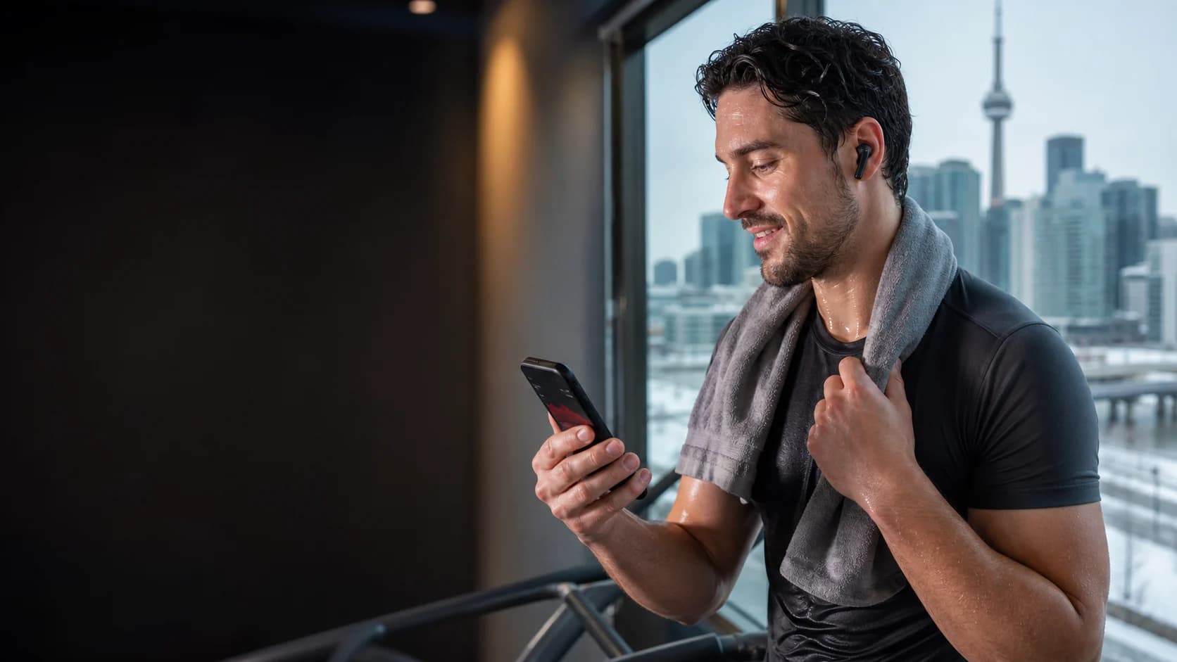 Representative athlete checking workout data while wearing wireless earbuds