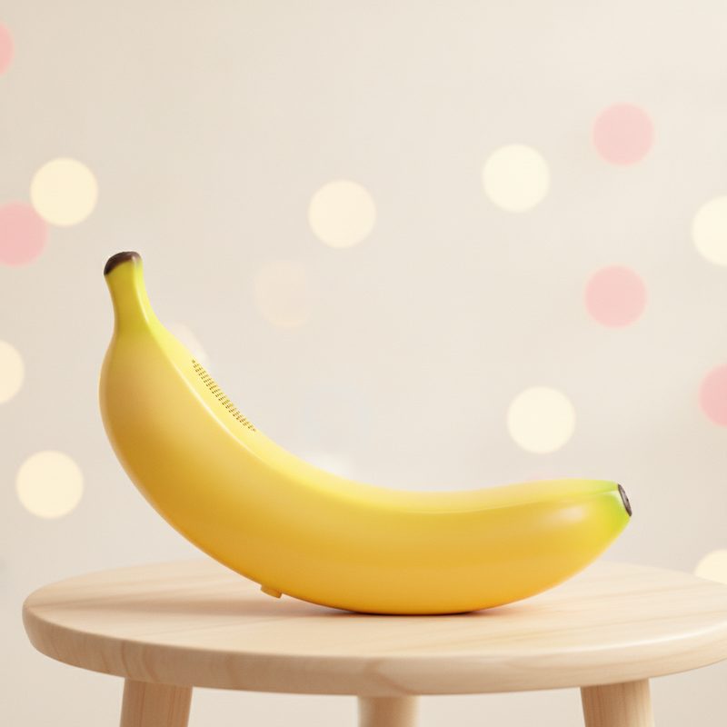 Representative bright yellow banana-shaped phone handset on a side table