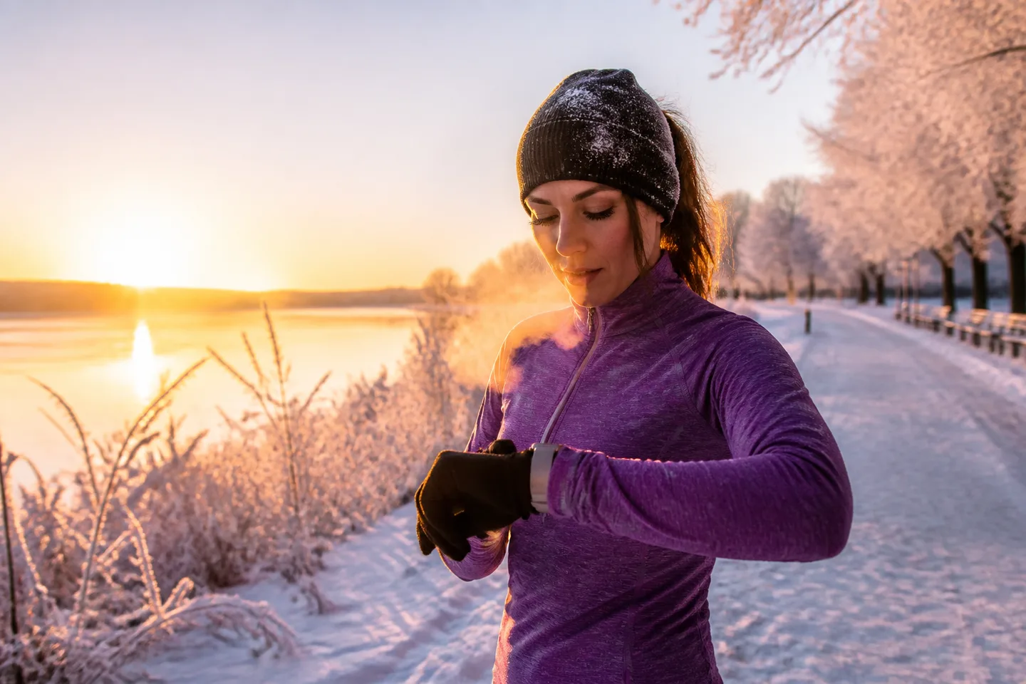 Representative slim smartwatch being checked during a winter run