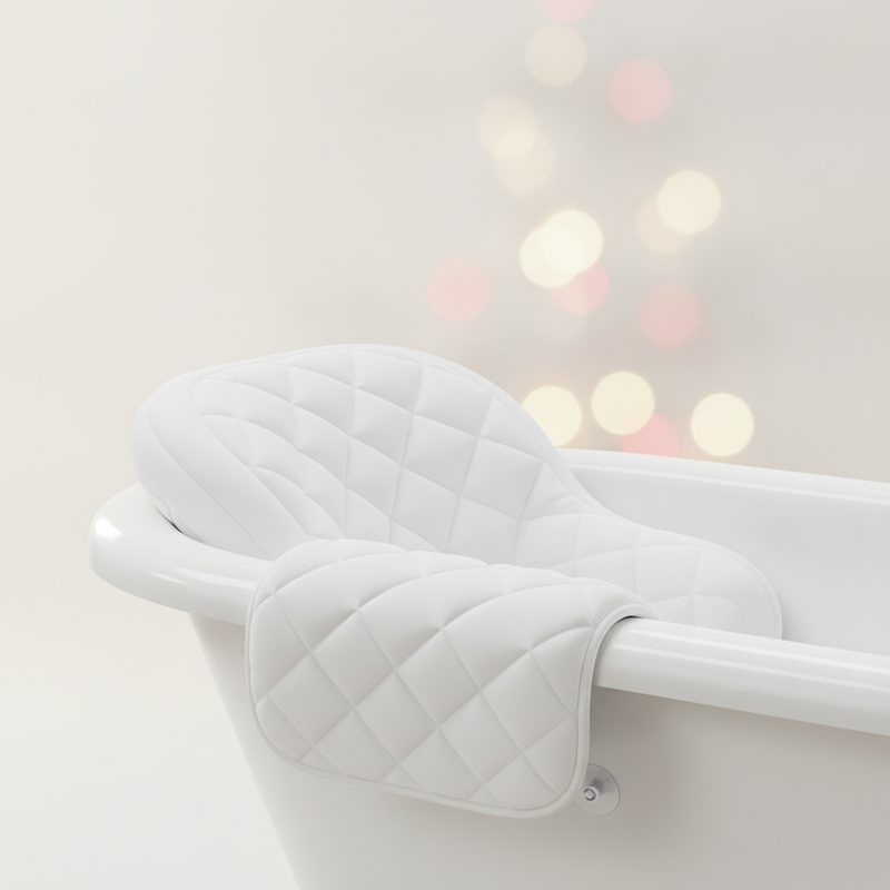 Representative cushioned bath pillow draped over the rim of a tub