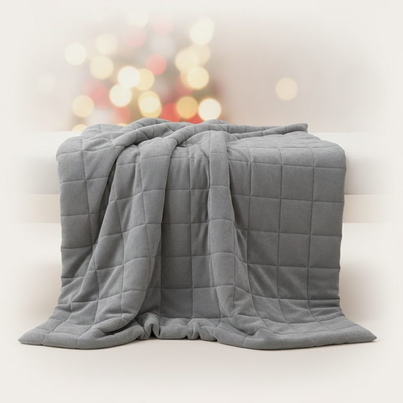 Representative weighted blanket draped heavily over a person reading on a couch